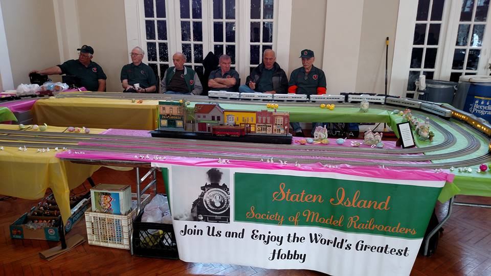 SISMR members at a spring community show with the club banner: Join Us and Enjoy the World's Greatest Hobby